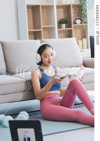 Young Asian sporty attractive people practicing yoga lesson with instructor. Asia group of women exercising healthy lifestyle in fitness studio. Sport activity, gymnastics or ballet dancing class. 137808494