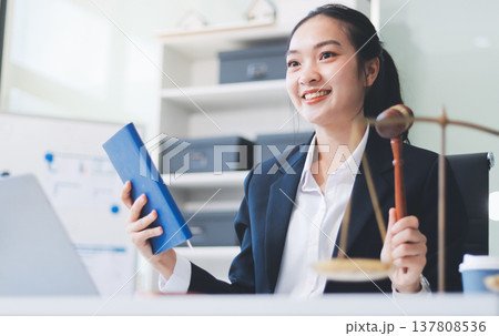 Lawyer explained to the client about the law that must be brought against the court case. Lawyer explained to the client about the law that must be brought against the court case. 137808536