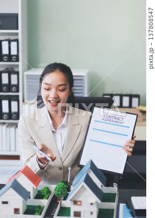 real estate agent home miniature model on documents sale and purchase of apartment notarial deed real estate agent home miniature model on documents sale and purchase of apartment notarial deed 137808547