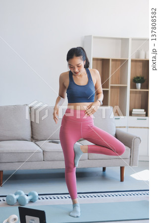 Young Asian sporty attractive people practicing yoga lesson with instructor. Asia group of women exercising healthy lifestyle in fitness studio. Sport activity, gymnastics or ballet dancing class. Young Asian sporty attractive people practicing yoga lesson with instructor. Asia group of women exercising healthy lifestyle in fitness studio. Sport activity, gymnastics or ballet dancing class. 137808582