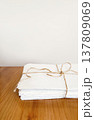 Stack of waste paper tied with twine for recycling on wooden table 137809069