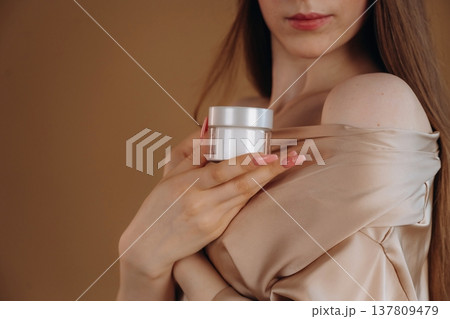 Showing the product. Close up view of woman that is with cream for skin 137809479