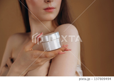 Close up view of woman that is with cream for skin Close up view of woman that is with cream for skin 137809494