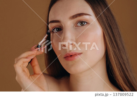 Make up, cosmetics conception. Young woman is against background 137809522