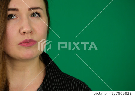Different emotions of a woman's pose in black on a green background 137809822