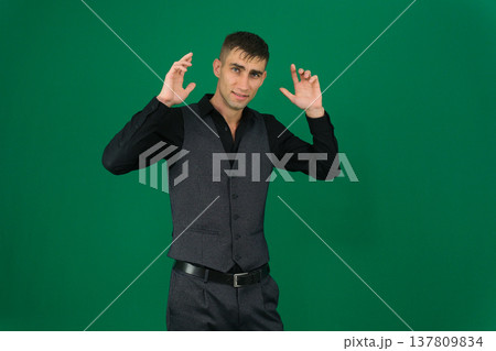 Various emotions and movements of a man in a gray suit on a green background in a vest and pants, many different poses 137809834