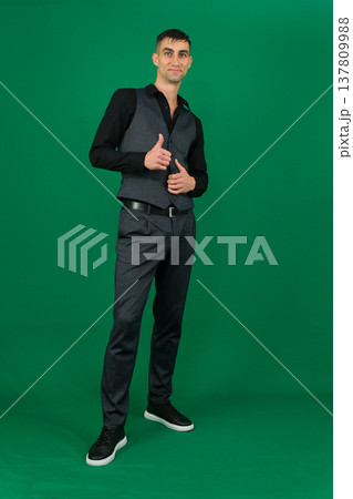 Various emotions and movements of a man in a gray suit on a green background in a vest and pants, many different poses Various emotions and movements of a man in a gray suit on a green background in a vest and pants, many different poses 137809988