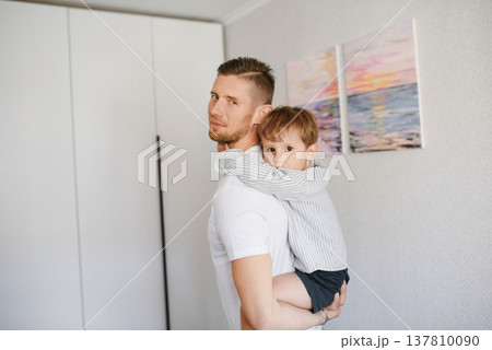 Father Holding Little Boy In Home Interior Father Holding Little Boy In Home Interior 137810090
