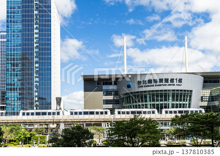 A train on the Wenhu or Brown Line of the Taipei MRT passes by the modern metropolis building in Nangang Software Park Area. 137810385