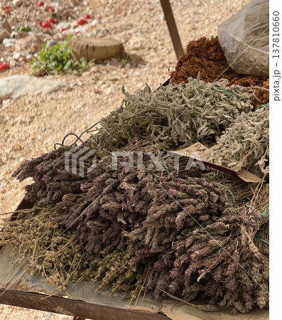 Dried herbs displayed at outdoor market stall in rustic setting Dried herbs displayed at outdoor market stall in rustic setting 137810660