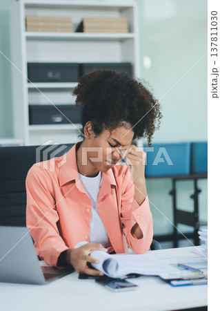 Businesswoman get stressed and headache while having a problem at work in office Businesswoman get stressed and headache while having a problem at work in office 137811030