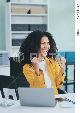 Pretty female freelancer working on laptop while sitting on modern coworking background Pretty female freelancer working on laptop while sitting on modern coworking background 137811047
