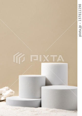 Natural cosmetic background for product presentation. White podiums on the sand. Front view. Natural cosmetic background for product presentation. White podiums on the sand. Front view. 137811198
