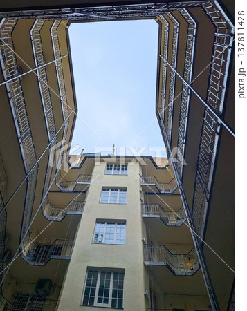 Low angle view of apartment building courtyard 137811428