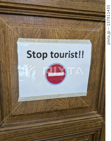 Stop tourist sign on wooden door 137811435
