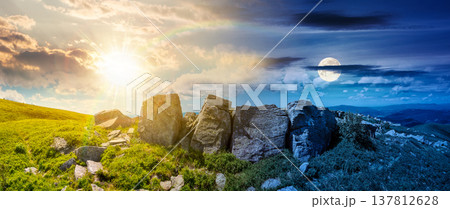 mountainous panorama with huge stones near hillside. day meet night. beautiful summer solstice landscape on a cloudy weather. sun and moon over alpine scenery with green grassy meadow. epic outdoors mountainous panorama with huge stones near hillside. day meet night. beautiful summer solstice landscape on a cloudy weather. sun and moon over alpine scenery with green grassy meadow. epic outdoors 137812628