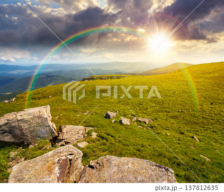alpine mountain landscape at sunset. untouched grass and sharp sandstone on wide meadow in evening light. travel background for hiking in summer. rolling earth day wallpaper with rainbow 137812635
