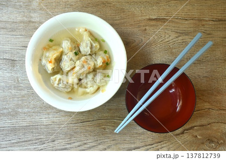 Chinese dumpling topping slice red barbecue pork with clear soup on bowl 137812739