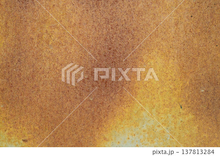 A horizontal close-up shot of a heavily oxidized metal surface, featuring a dense and uniform texture of orange and brown rust. 137813284
