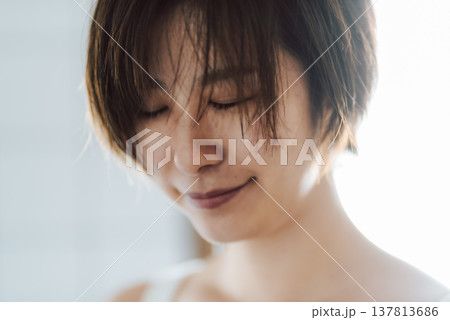 目を閉じて微笑む女性の顔 137813686