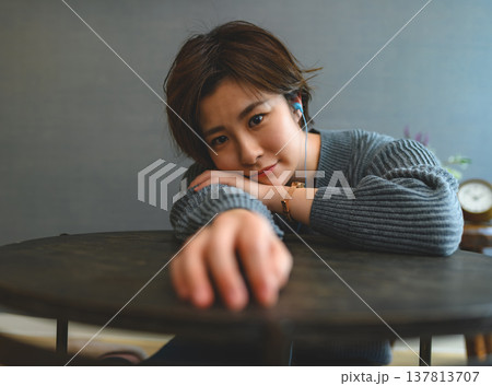 テーブルに肘をつく女性 テーブルに肘をつく女性 137813707