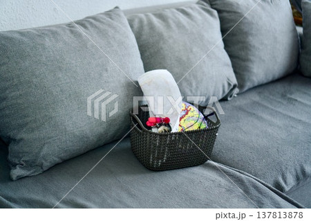 Cozy Knitting Basket with Yarn Balls on Grey Sofa Cozy Knitting Basket with Yarn Balls on Grey Sofa 137813878