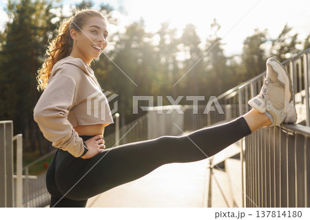 Athletic young woman training outdoors. Fitness woman stretching outdoors. Active lifestyle. Athletic young woman training outdoors. Fitness woman stretching outdoors. Active lifestyle. 137814180