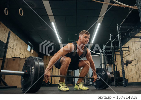 No pain, no gain, weightlifting. Athletic man is with a barbell in a gym No pain, no gain, weightlifting. Athletic man is with a barbell in a gym 137814818