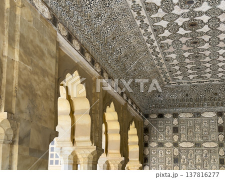Jaipur palace interior displays intricate mirror mosaic ceiling and ornate arch detail. Historic 137816277