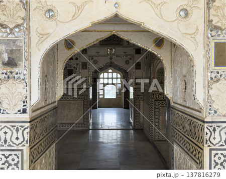 Jaipur palace interior features ornate arch corridor with mirror mosaic and decorative pattern. 137816279