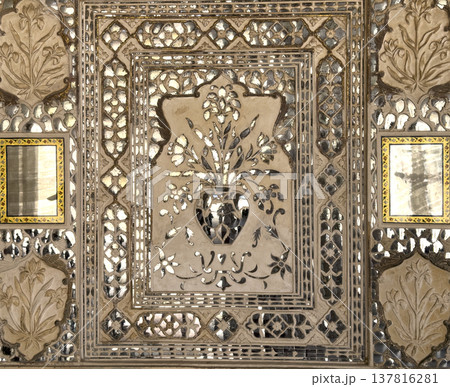 Jaipur palace wall features intricate mirror mosaic with floral ornament and geometric pattern. 137816281