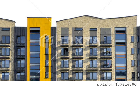 Modern apartment building facade in urban residential area. Brick exterior with yellow accent and 137816306