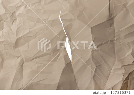 Vertical ripped brown kraft paper shows narrow torn split through crumpled textured surface. Jagged Vertical ripped brown kraft paper shows narrow torn split through crumpled textured surface. Jagged 137816371
