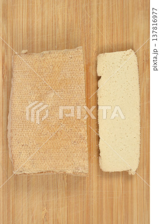 Top view of smoked tofu block and slice on wooden board Top view of smoked tofu block and slice on wooden board 137816977