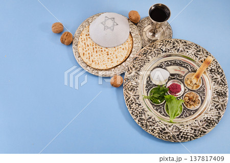 Passover seder plate with matzah, kippah, and wine Passover seder plate with matzah, kippah, and wine 137817409