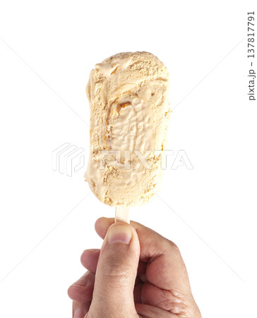 Vanilla ice cream popsicle in hand isolated on white 137817791