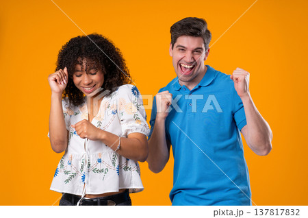 Positive American Interracial Couple Dancing. Yellow Wall. Music, Dance, Party Positive American Interracial Couple Dancing. Yellow Wall. Music, Dance, Party 137817832