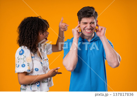 Angry Woman Yelling At Tired Man, He Covering Ears With Hands. Couple Burnout Angry Woman Yelling At Tired Man, He Covering Ears With Hands. Couple Burnout 137817836