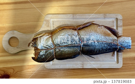Cold hot smoked mackerel, beautifully laid out on a wooden chopping board, is ready for cooking and serving and is perfect for culinary themes. Cold hot smoked mackerel, beautifully laid out on a wooden chopping board, is ready for cooking and serving and is perfect for culinary themes. 137819083