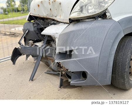 This minibus was significantly damaged as a result of a serious head-on collision. A seriously damaged grey minibus, which shows significant collision marks in the front and extensive rust marks. This minibus was significantly damaged as a result of a serious head-on collision. A seriously damaged grey minibus, which shows significant collision marks in the front and extensive rust marks. 137819127