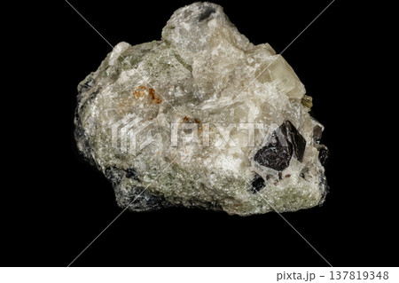 Macro stone Apatite and magnetite mineral on parade on black background Macro stone Apatite and magnetite mineral on parade on black background 137819348