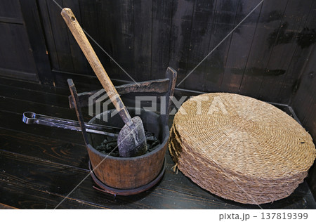 古民家の黒光りする床に置かれた伝統的な炭桶と藁座布団が醸し出す冬の情緒 137819399