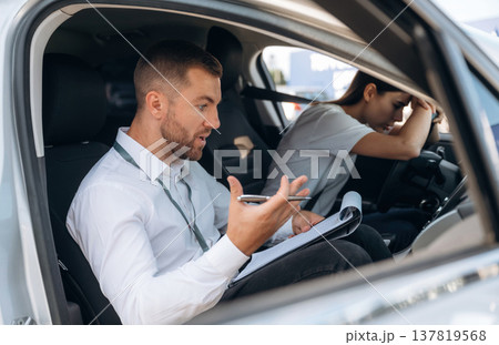 Disappointed, failure. Woman is with instructor in car, driving school concept 137819568