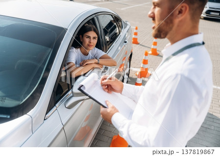 Writing results into notepad. Woman is trying to pass exam in the driving school 137819867