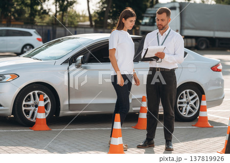 Discussing the results. Woman is trying to pass exam in the driving school 137819926