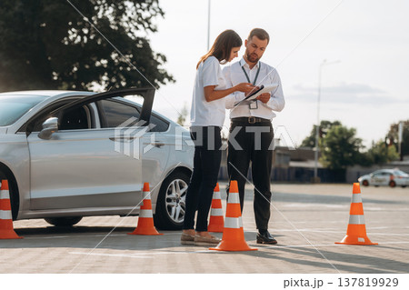 Discussing the results. Woman is trying to pass exam in the driving school 137819929