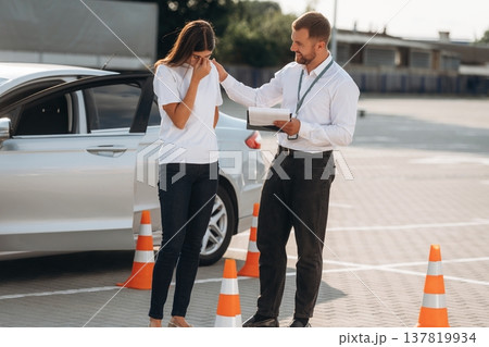 Sad, didn't pass the test. Woman is trying to pass exam in the driving school Sad, didn't pass the test. Woman is trying to pass exam in the driving school 137819934