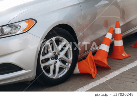 Car is on the parking lot with orange colored cones, driving school conception Car is on the parking lot with orange colored cones, driving school conception 137820249