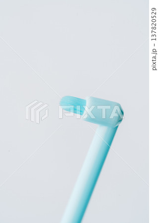 Macro view of single tuft toothbrush head, minimal dental cleaning concept on light background 137820529
