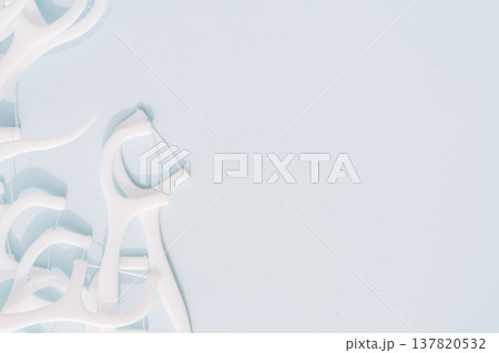 White dental floss picks scattered on light blue background, oral hygiene concept with copy space 137820532